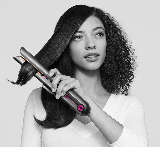 Woman drying her hair with the Dyson supersonic hair dryer