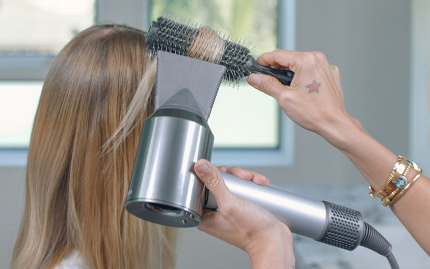 Professional stylist using the Dyson Supersonic hair dryer Professional